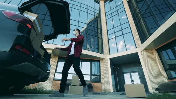 Courier Is Taking Boxes Out of the Car for Contact-free Delivery