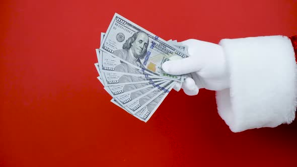 Santa Claus Hand Throw Money Into Air Red Background