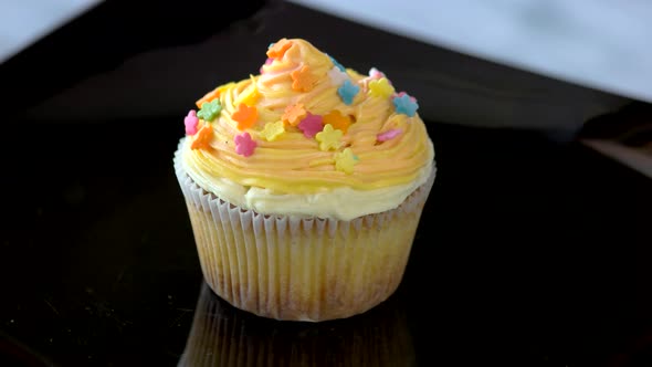 Cupcake with Delicate Cream on Plate