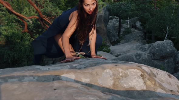 Young Woman Relaxing Outdoors Enjoying a Lifestyle of Outdoor Travel Climbing Steep Rocky Terrain