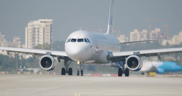 Slow motion shot of passenger airplane taxiing at the airport