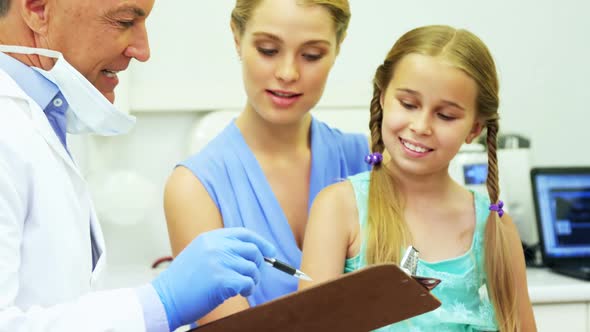 Dentist interacting with young patient