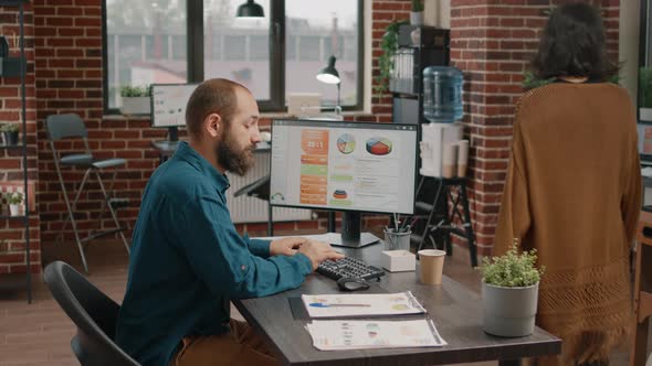 Business Man Working with Data Rate Charts on Computer