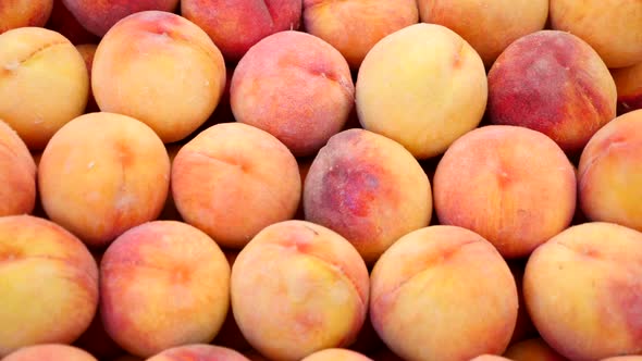 Close Up Of Peaches For Sale At A Market Stall. Fruit Background.