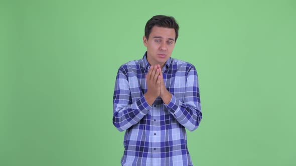 Young Handsome Hipster Man Praying
