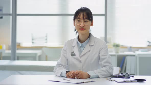 Asian Female Doctor Posing at Workplace in Medical Office