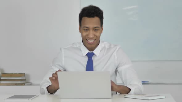 AfroAmerican Businessman Celebrating Success Working on Laptop