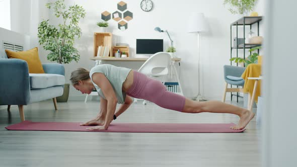 Slow Motion of Skilled Young Woman Stretching Body and Exercising Indoors at Home