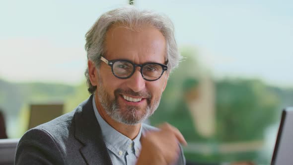 Smiling bearded man looking at camera