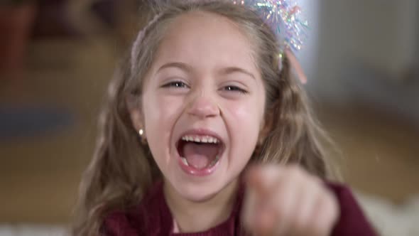 Closeup Face of Cheerful Pretty Girl Laughing Out Loud Pointing at Camera