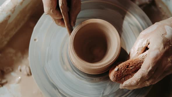 Hands of Woman Working on a Pottery Wheel. Creating a Ceramic Pot. Closeup. Arts Lessons and Pottery