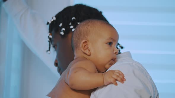 African American Black Man Father Holding a Child in His Arms