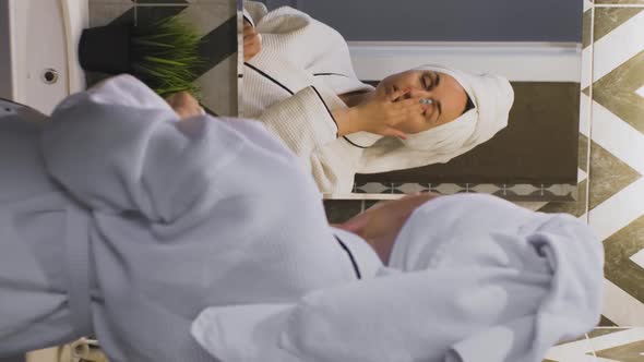 Woman Applying Creme on Face After Shower