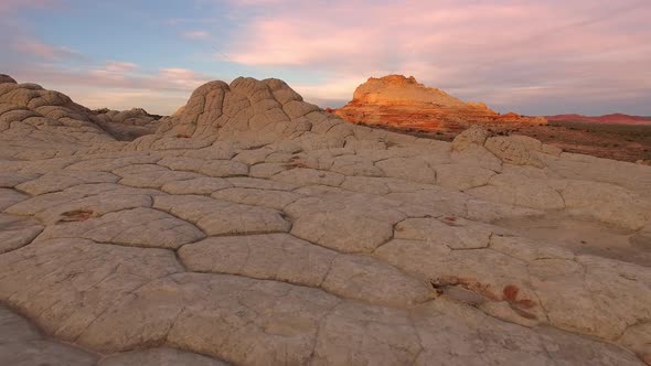 Flying view over desert terrain at sunrise