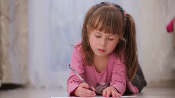 Pretty Child Girl Drawing a Postcard to Her Mother for Happy Mothers Day with Words I Love My Mom