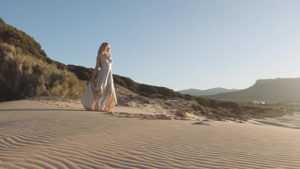 Beautiful Dancing Blond Woman In Dress On Beach