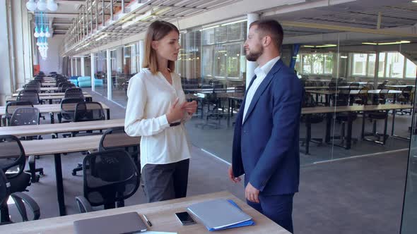 Colleagues Talking in Empty Office