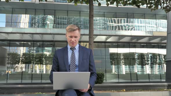 Businessman Leaving After Working on Laptop Outside Officeice