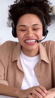 Vertical Video of a Pretty African American Stylish Girl with Headset Mentor or Student Conducts an