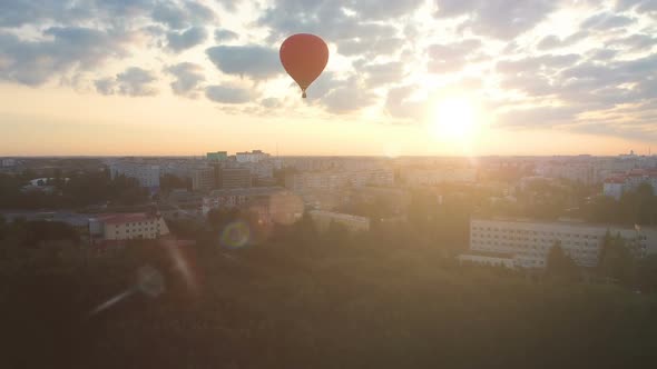 Sun Rising on Horizon, Red Hot Air Balloon Floating Over City, Cherished Dreams