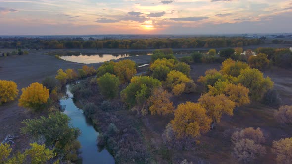 A fall rainbow of brilliant colors and vivid reflections as the sunset blends into the tree canopy a