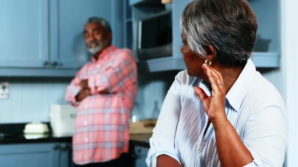 Senior couple ignoring with each other in kitchen