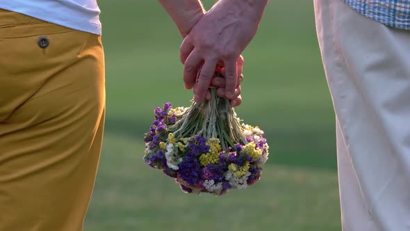 Hands Senior Couple Holding Flowers Outdoors