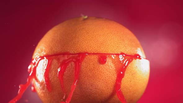Half Grapefruit Falling and Splashing on Fuchsia Background