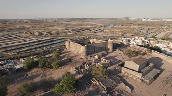 Aerial dolly out showcasing medieval Castle of Castro Marim and the remains within fortification