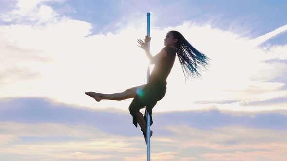 Pole Dance on Nature - Woman with Blue Braids in Black Dress Holding By the Pole and Dancing on the