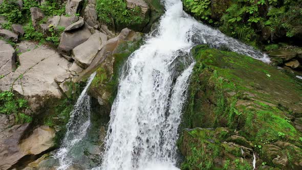 Mountain River Waterfall Flowing Between Rocky Shores in Carpathians Mountains Ukraine