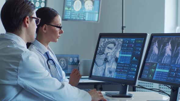 Professional medical doctors working in hospital office making computer research.