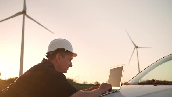 Technician Engineer Working at Wind Turbine Using Laptop Computer Worker or Operator Checks Wind