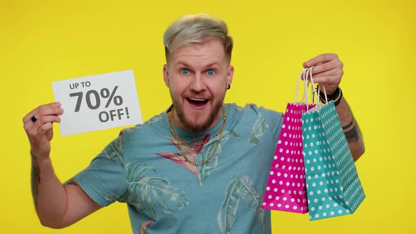 Cheerful Tourist Man Showing Shopping Bags and Up To 70 Percent Off Inscriptions Banner Black Friday