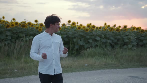 Handsome Man Stands and Smiling on the Road