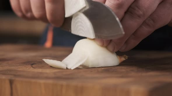 Close Up Footage Chef in Restaurant Kitchen Cuts White Onion with Sharp Shiny Knife