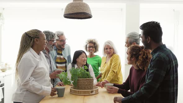 Happy multiracial people with different ages and ethnicities having fun drinking a cup of coffee