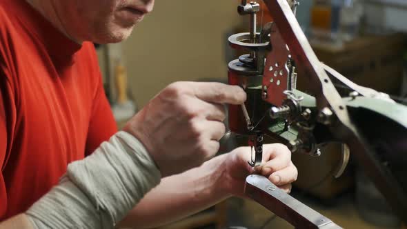 Shoemaker Installs Shoe in Mechanical Sewing Machine for Stitching