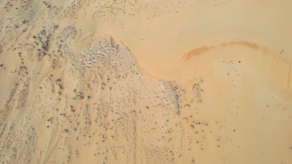 aerial top down landscape of dry arid rocky sand dunes in the desert