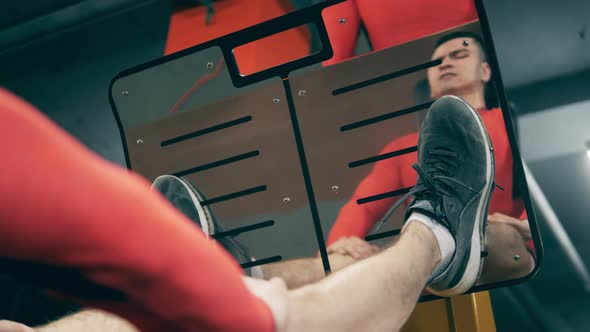 Fitness Machine Is Being Used By an Athlete To Strengthen His Legs