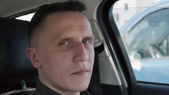 Portrait of a Man Sitting in a Car