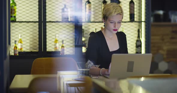 Businesswoman Working On Laptop In Coffee Shop