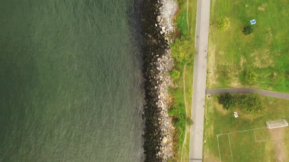 A top down shot over the stoney shores of the East River near the Throgs Neck Bridge. It is a cloudy