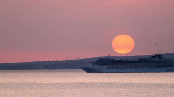 Cruise Ship Sail in Sea on Sunset with Sun