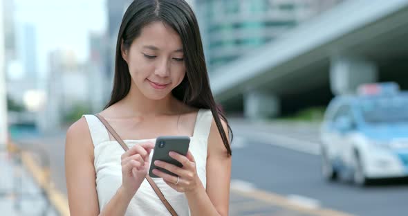 Young woman use the app on cellphone in city