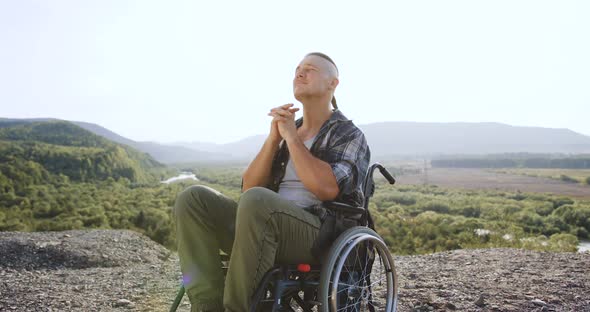 Disabled Guy in Wheelchair which Thinking About His Life After Accident or Desease on the Hill