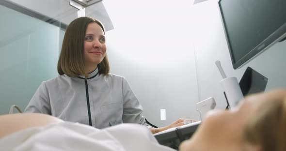 Portrait of Young Attractive Female Doctor Posing to Camera with Smile While