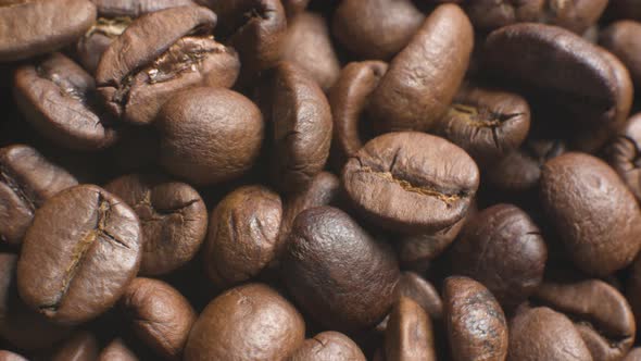 a Set of Coffee Beans After Roasting in a Coffee Shop in a Wooden Cup on a Black Background Rotating