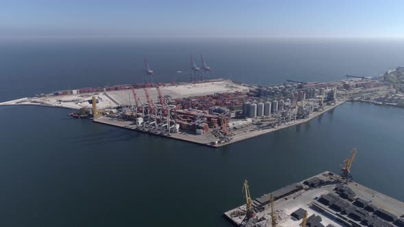 Industrial Sea Wharf with Containers and Lifting Cranes on Sea Shore