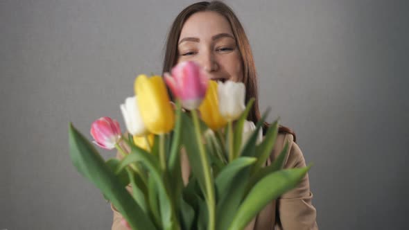 Beautiful Girl Getting a Bouquet of Tulips